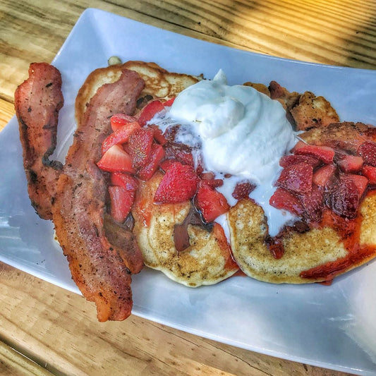 Bacon Pancakes with Strawberry Whiskey Syrup and Whipped Cream